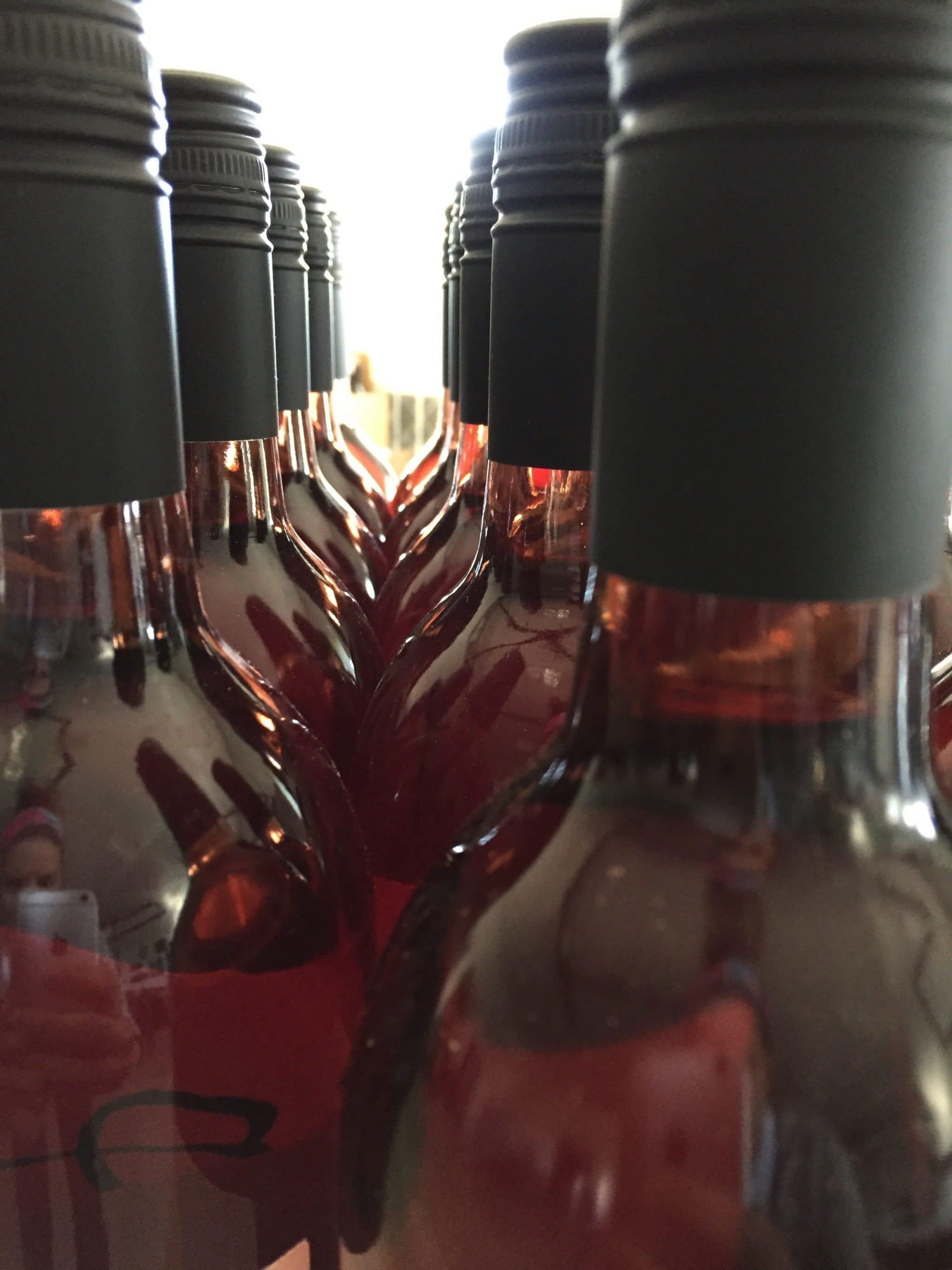 Close-up of wine bottle tops and capsules viewed from below