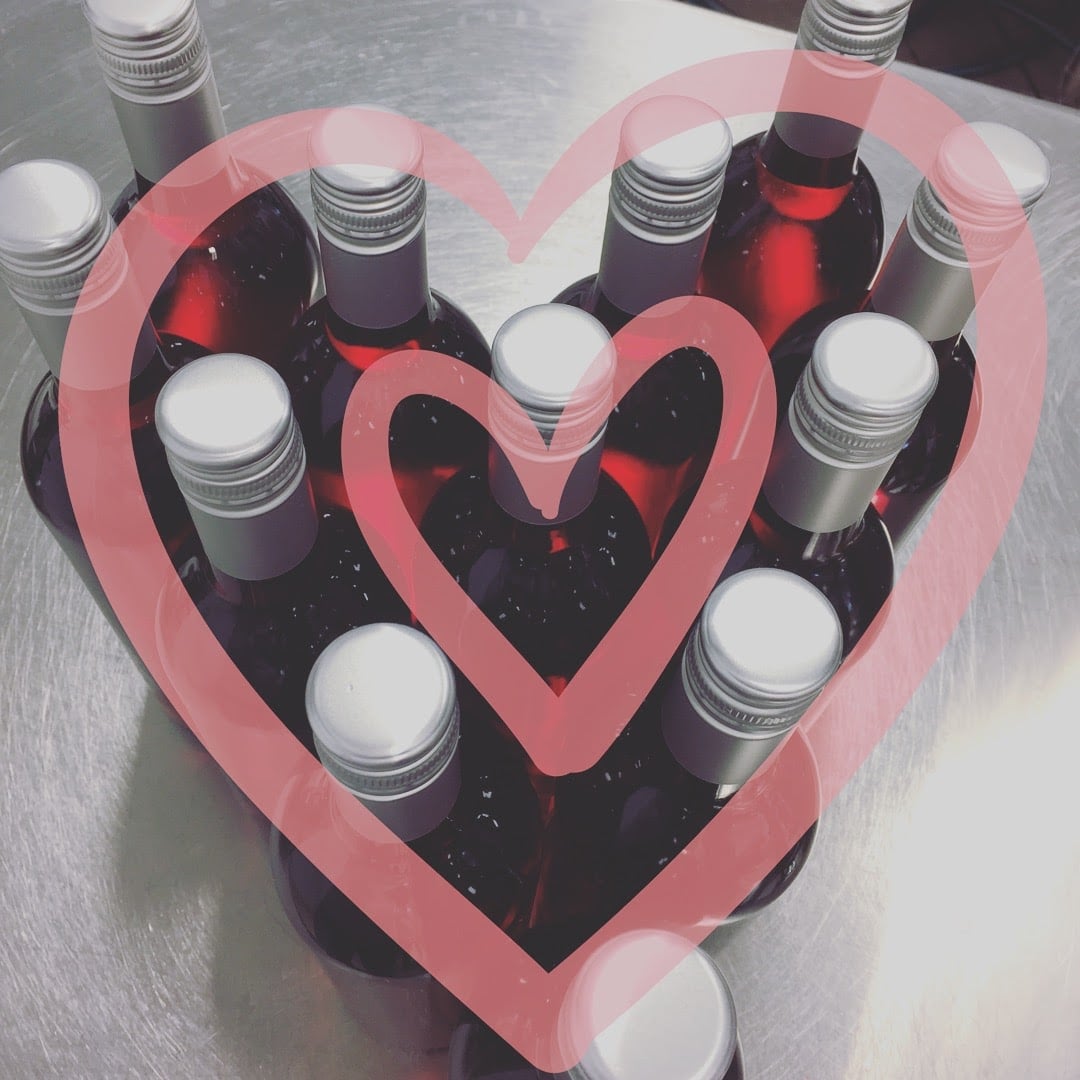 Soldier Creek Winery wine bottles arranged in a heart shape for Valentine's Day