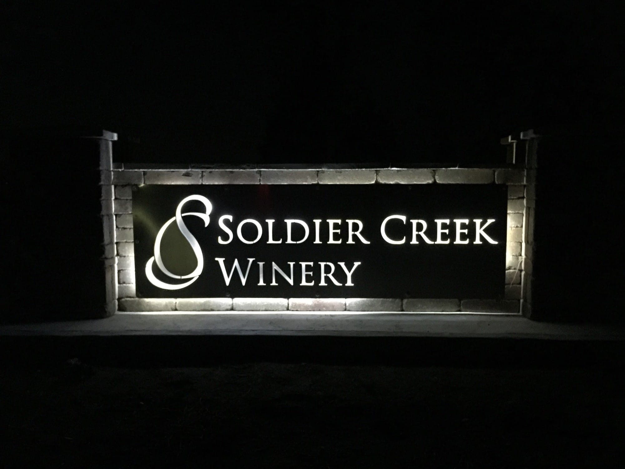 Soldier Creek Winery illuminated entrance sign at night