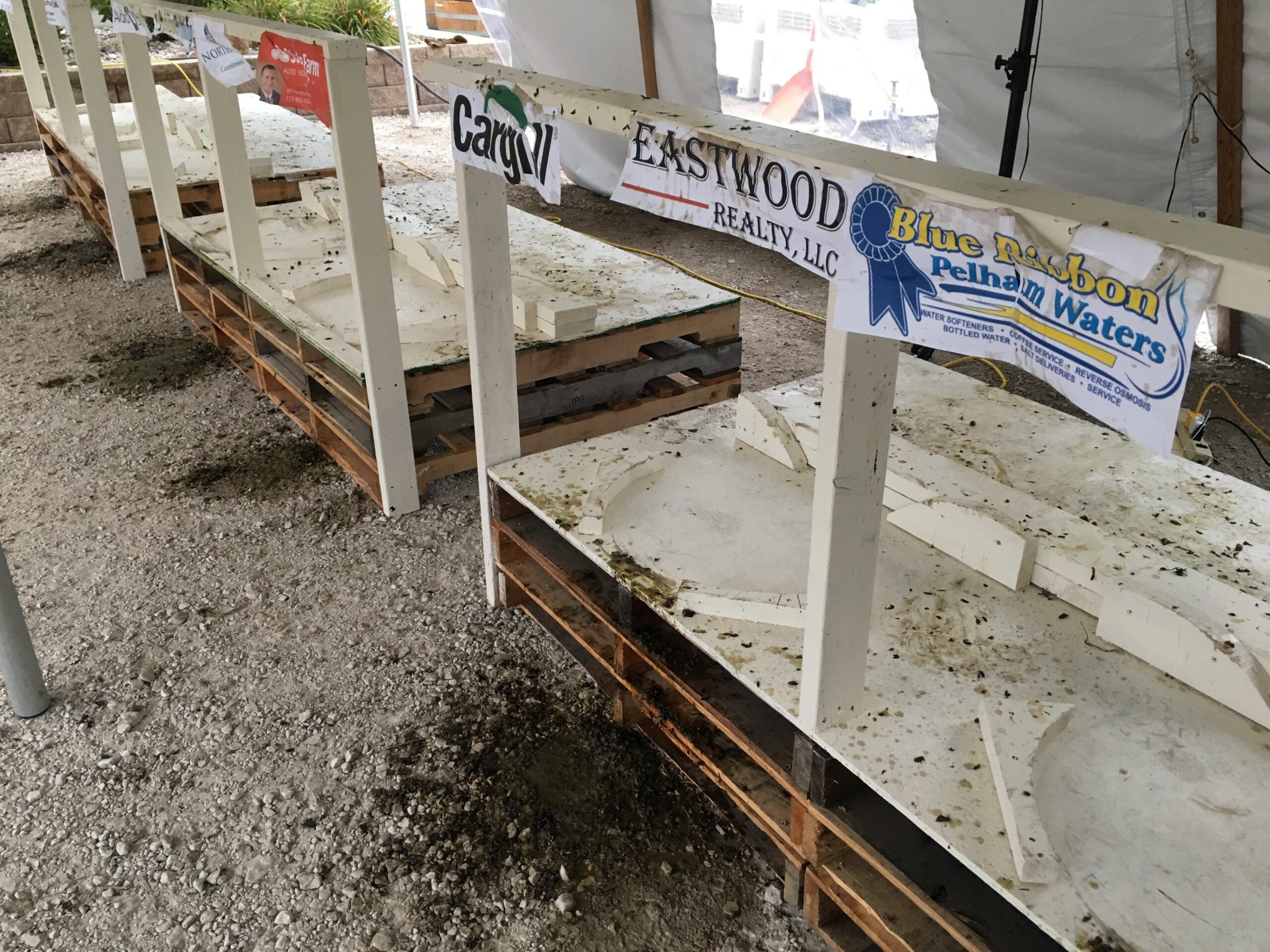 Outdoor event venue with concrete barriers and sponsor signs including Cargill and Eastwood Realty