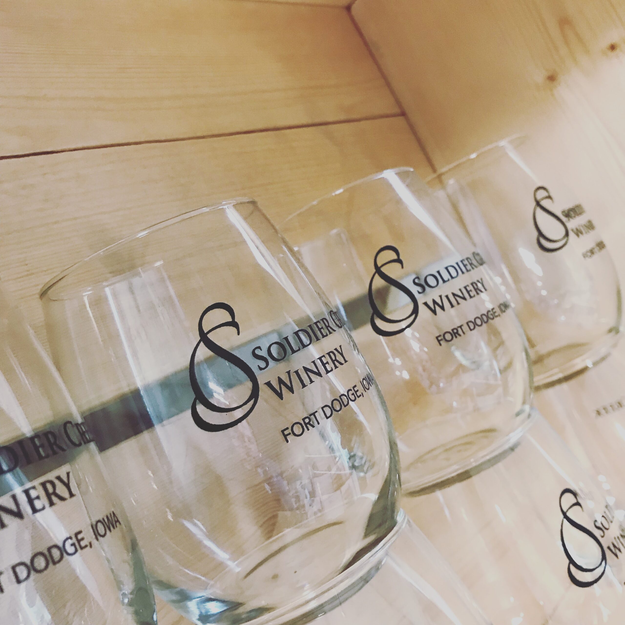 Two Soldier Creek Winery branded stemless wine glasses side by side showing the winery logo