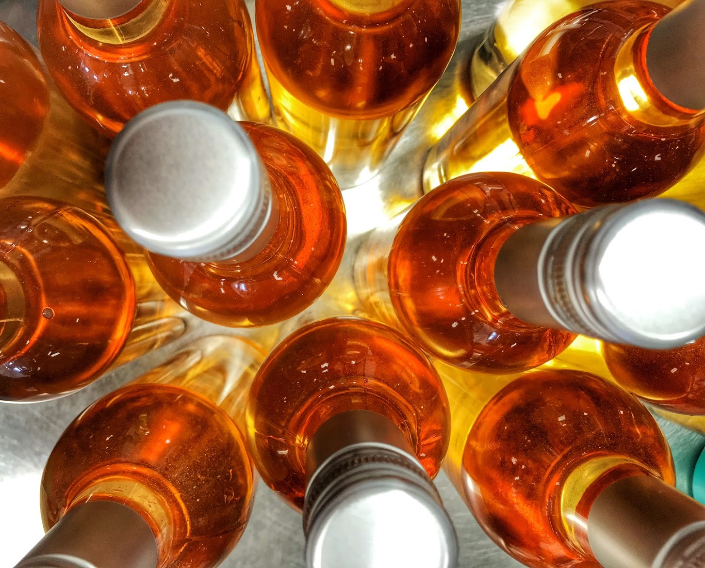 Overhead close-up view of Soldier Creek Winery wine cans showing their metallic gold and amber tops