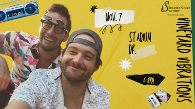 A fun, retro-themed poster featuring two smiling men in printed shirts, one in sunglasses, with a yellow background. A blue boombox and cassette tapes add flair. Text reads: “Vineyard Vibrations,” “Nov. 7,” “Stadium Dr.,” and “6–8PM.” Soldier Creek Winery logo in the top right.